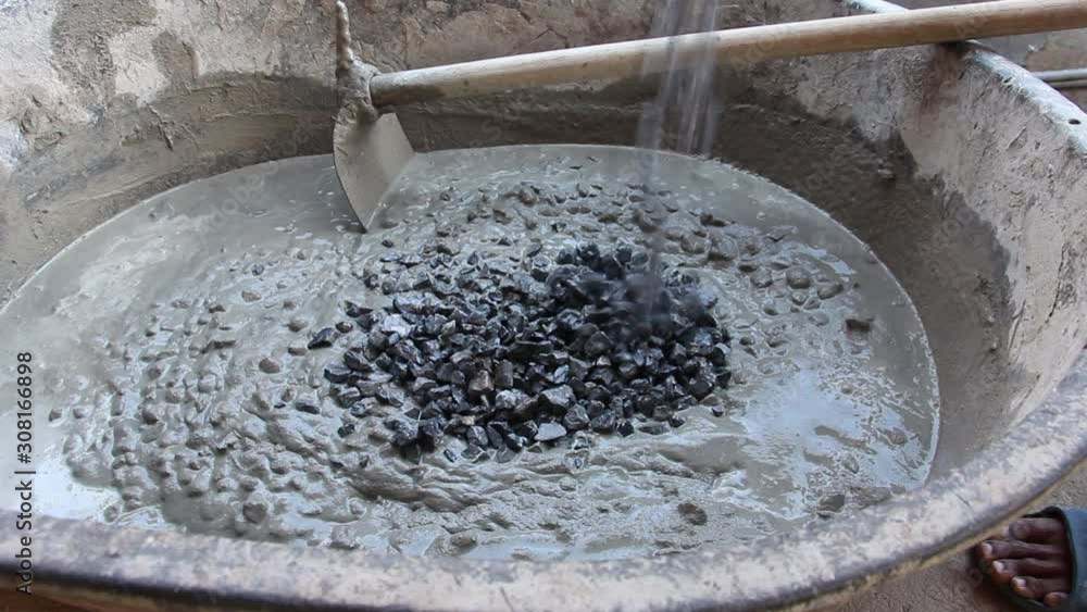 Labor mixing concrete for construction job,Mixing cement for the preparation of Construction. Labor mixing concrete for construction job,Mixing cement for the preparation of Construction.