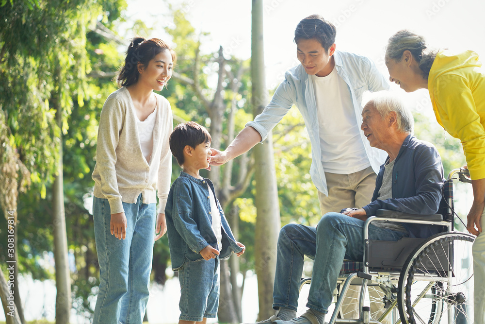 happy asian multi generation family relaxing outdoors happy asian multi generation family relaxing outdoors