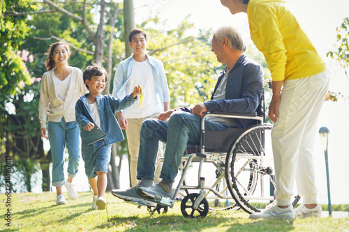 happy asian three generation family relaxing outdoors