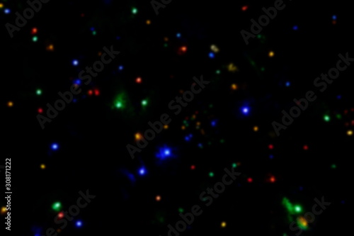 Garland lights on the Christmas tree. Blurred defocused christmas background for design.