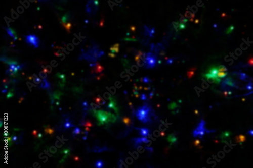  Garland lights on the Christmas tree. Blurred defocused christmas background for design.