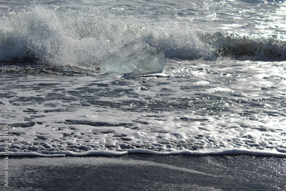 Naklejka premium large pieces of iceburg on black sand beach in Iceland