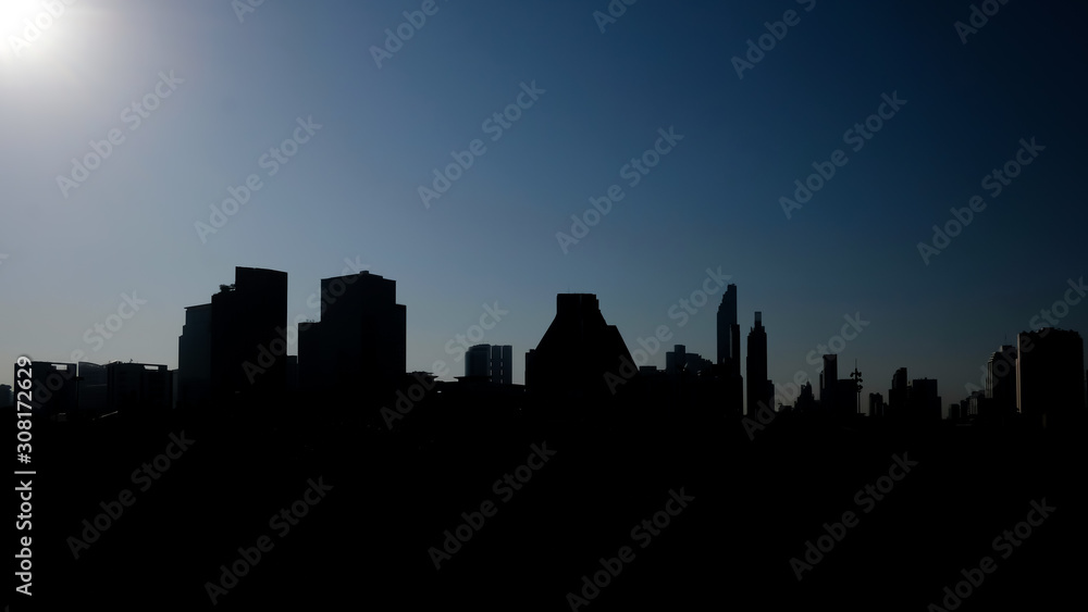 landscape of bangkok city silhouette and clear blue sky in morning time. with dark tone background.