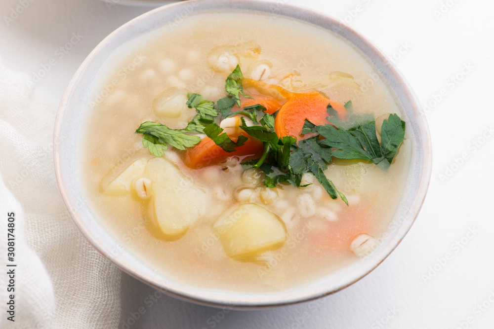 Barley soup, pearl barley in white bowl