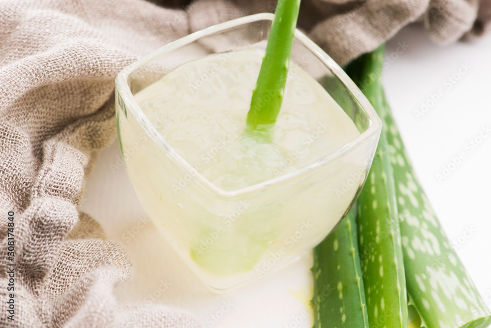 Glassware with fresh aloe vera juice and leaves Glassware with fresh aloe vera juice and leaves