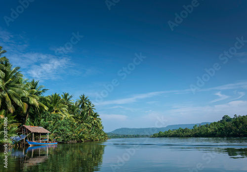 boat and jungle hut on the tatai river in cambodia photo