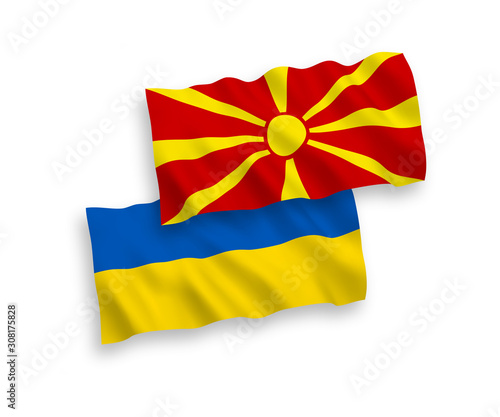 National vector fabric wave flags of North Macedonia and Ukraine isolated on white background. 1 to 2 proportion.