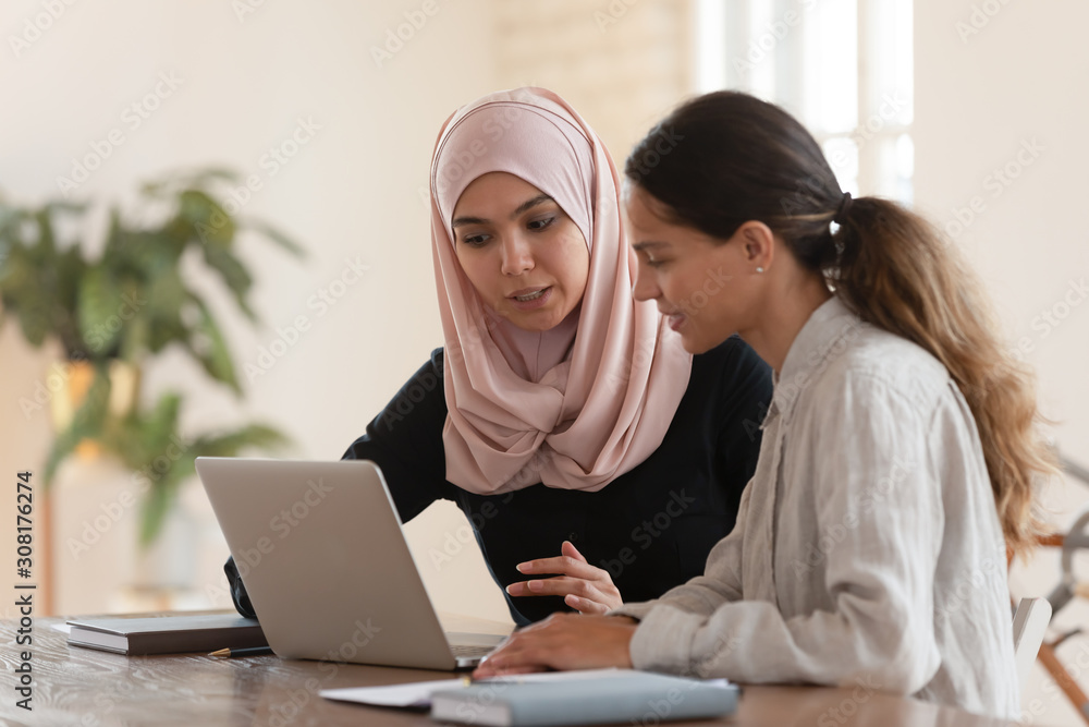 Focused team leader training millennial female intern. Focused team leader training millennial female intern.