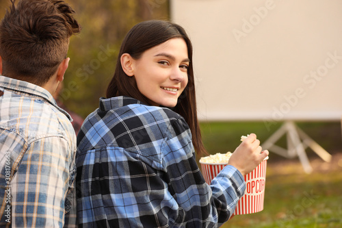 Young woman with popcorn in...