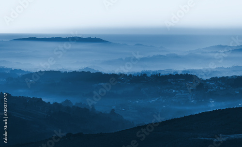 Layers of foggy mountains blue toned