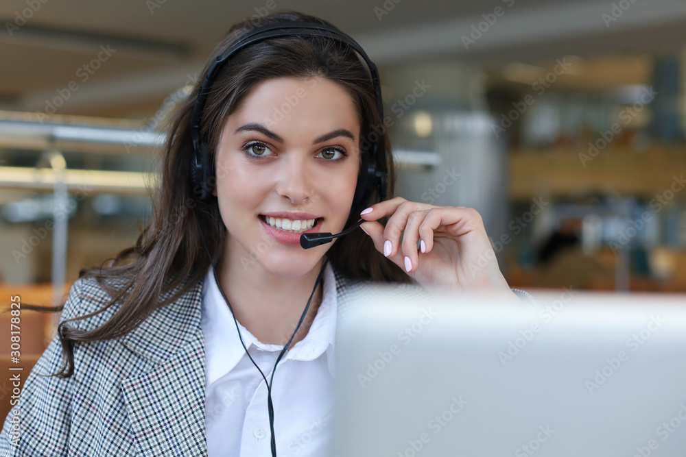 © ty - Female customer support operator with headset and smiling. © ty - Female customer support operator with headset and smiling.