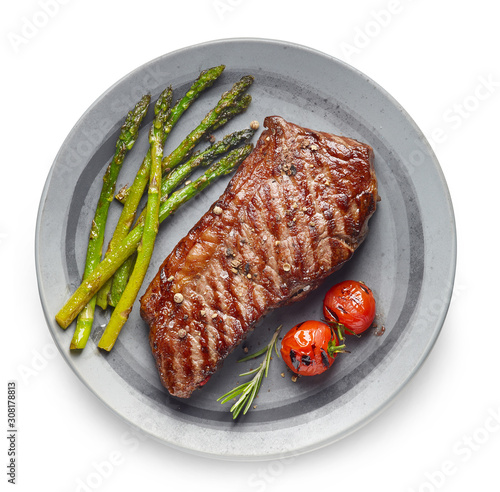 Cooked Beef steak on grey plate with asparagus and rosemary on white background