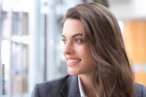 Attractive business woman smiling while standing in the office.