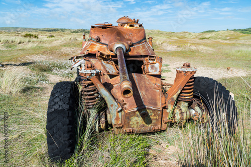 Memorials of WWII: A rusty tank in the bombed dunes near Biville, Normandy, France. photo