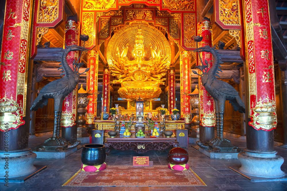 Golden Buddha Statue in the Bai Dinh Pagoda temple complex, Trang An, popular attraction of Ninh Binh, Vietnam 