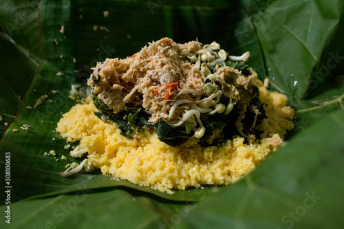 Indonesia or Javanese traditional food from corn, with gudangan (vegetables and coconut sambal) photo