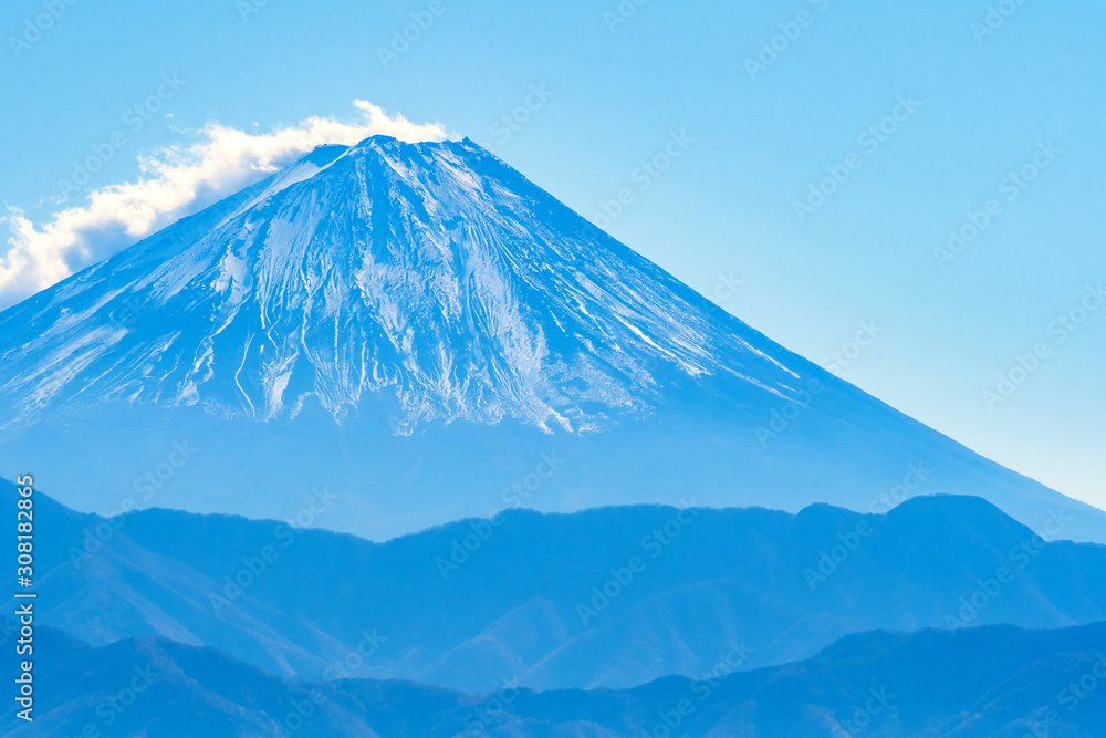 Fujiyama. Japan. Mount Fuji on the background of blue sky. Volcano. Nature of Southeast Asia. Japan travel guide. Landscape. Active stratovolcano on a Japanese island. Honshu island. Tour to Japan