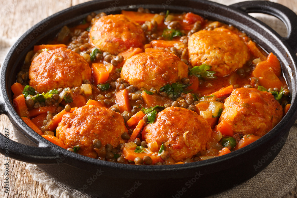 Moroccan meatballs served with lentils in tomato sauce close-up in a pan. horizontal Moroccan meatballs served with lentils in tomato sauce close-up in a pan. horizontal