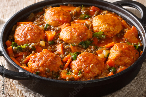 Moroccan meatballs served with lentils in tomato sauce close-up in a pan. horizontal