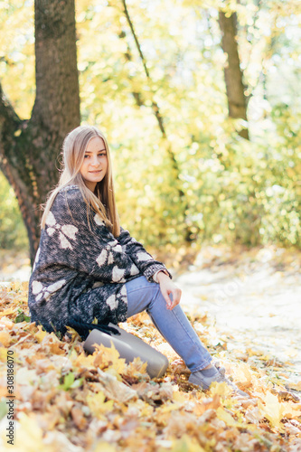 Portrait of young beautiful happy woman, autumn outdoors