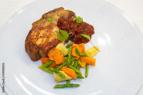 Steak with a side dish of v...