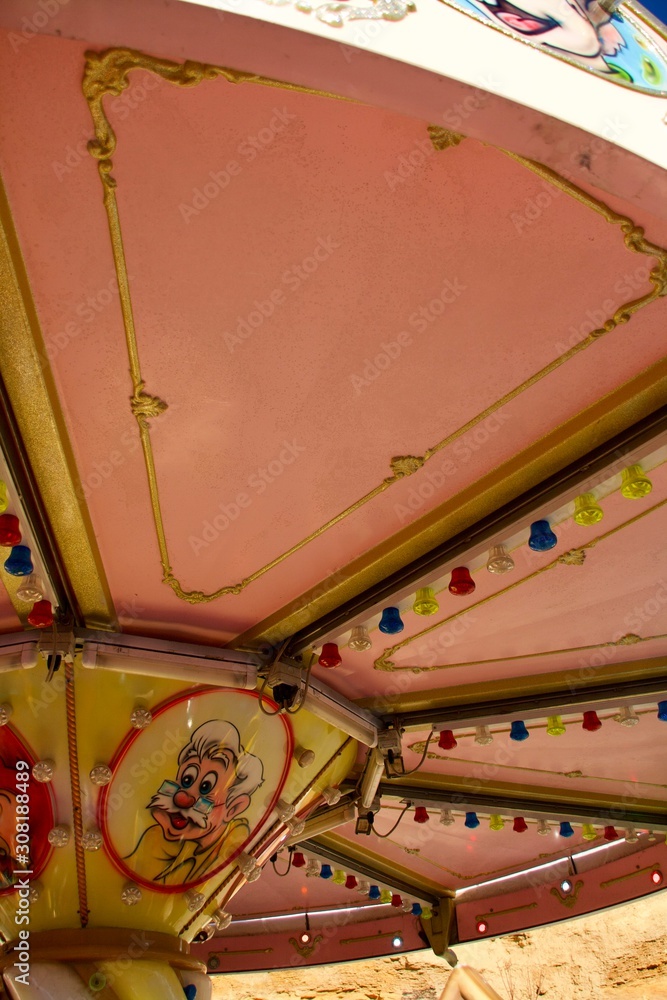 Naklejka premium vintage carousel at the fair against the blue sky