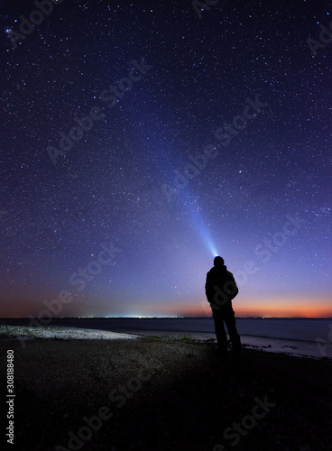 Lonely man at the beach under the stary sky