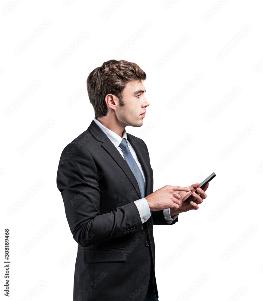 Serious businessman using smartphone, isolated Serious businessman using smartphone, isolated
