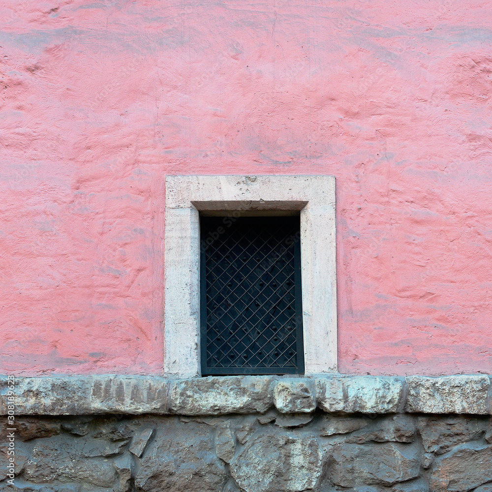 Window on an old pink stucco wall. Seamlees texture