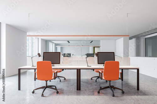 Modern office workplace with orange chairs