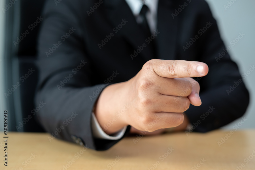 Fototapeta premium Business man pointing finger at you at desk