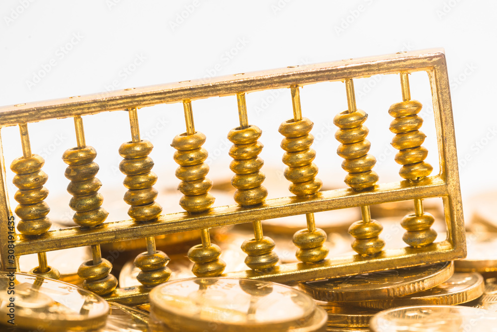 A gold abacus was placed on the background of the pile of COINS A gold abacus was placed on the background of the pile of COINS