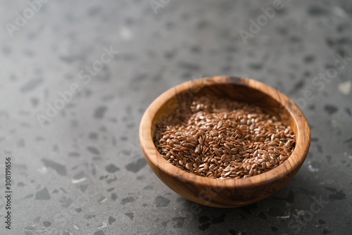 Wallpaper Mural Flax seeds in olive wood bowl on terrazzo surface with copy space Torontodigital.ca