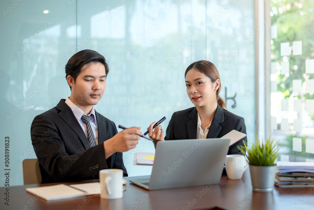 Modern business people discussing work in office and using laptop together while working. Modern business people discussing work in office and using laptop together while working.