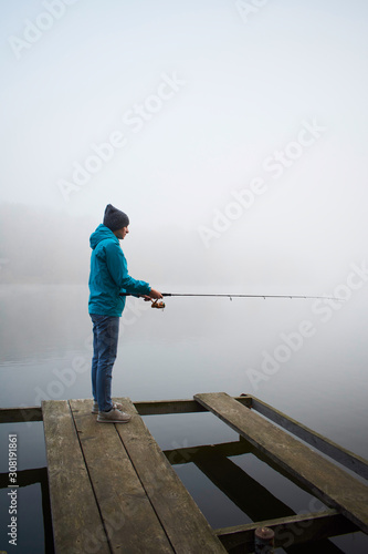 Woman catching fish angling at the lake
