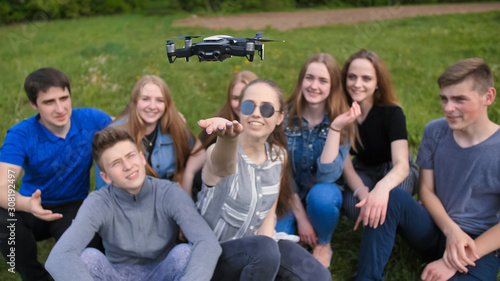 Happy cheerfulfriends launch a drone from their hands.