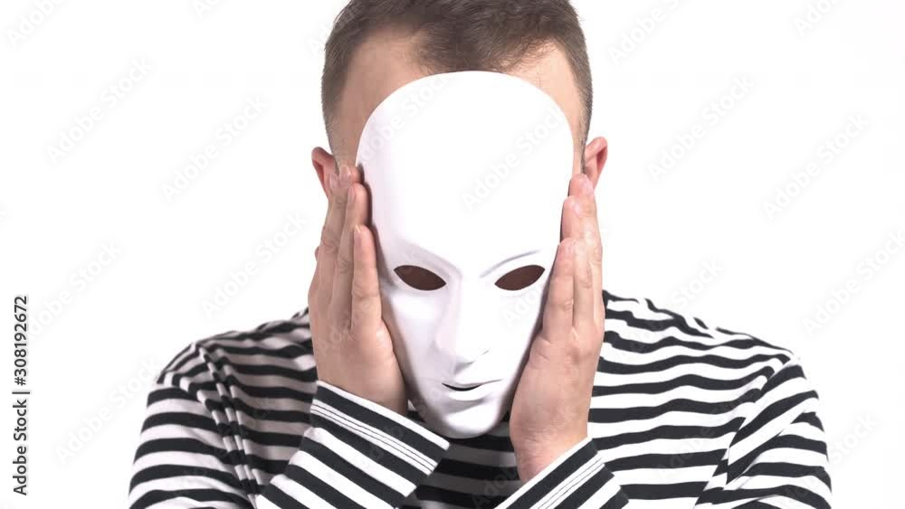 Young Caucasian man in white facial mask slowly taking it off. Isolated, on white background Young Caucasian man in white facial mask slowly taking it off. Isolated, on white background