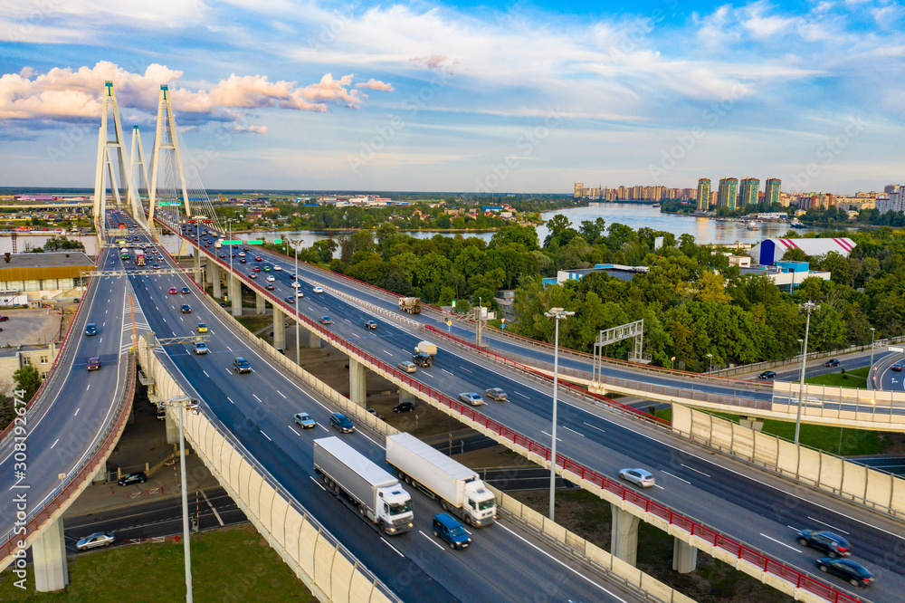 Saint Petersburg. Russia. Highway in St. Petersburg. Trucks are driving on the freeway. Concept - cargo transportation to Petersburg. The bridge across the Neva. Roads of Russia. Express road.