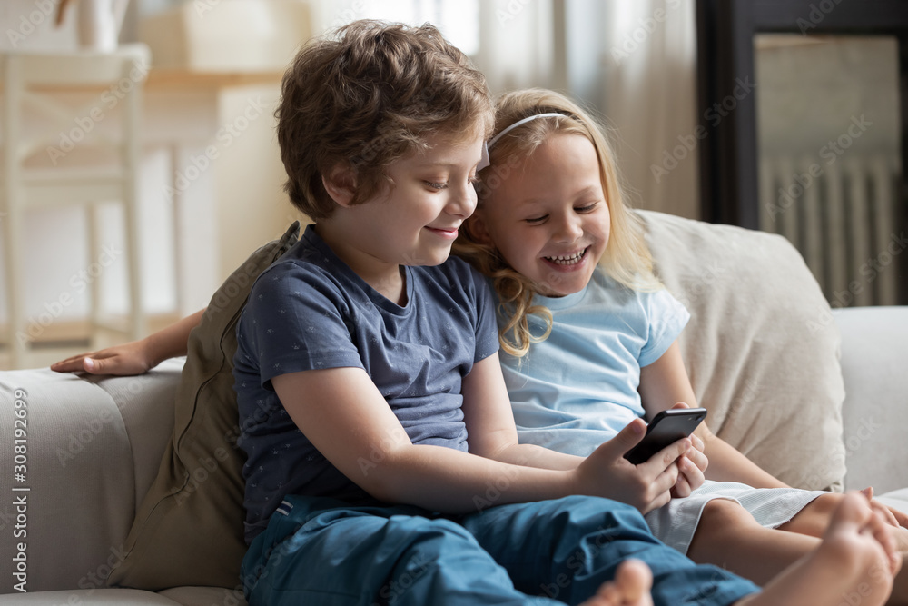 Little kids using smartphone spend free time on-line at home Little kids using smartphone spend free time on-line at home