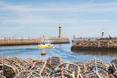 Whitby lobster pots.  The view across lobster fishing pots stacked on the keyside of the seaside town of Whitby in Yorkshire, Northern England.