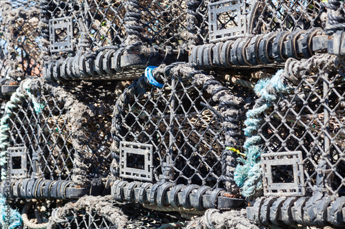 Lobster Fishing Pots.  A close up of lobster fishing pots stacked on the keyside of the seaside town of Whitby in Yorkshire, Northern England. photo