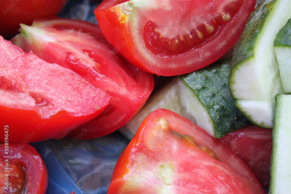 Sliced vegetables cucumbers and tomatoes close-up, background, wallpaper Sliced vegetables cucumbers and tomatoes close-up, background, wallpaper