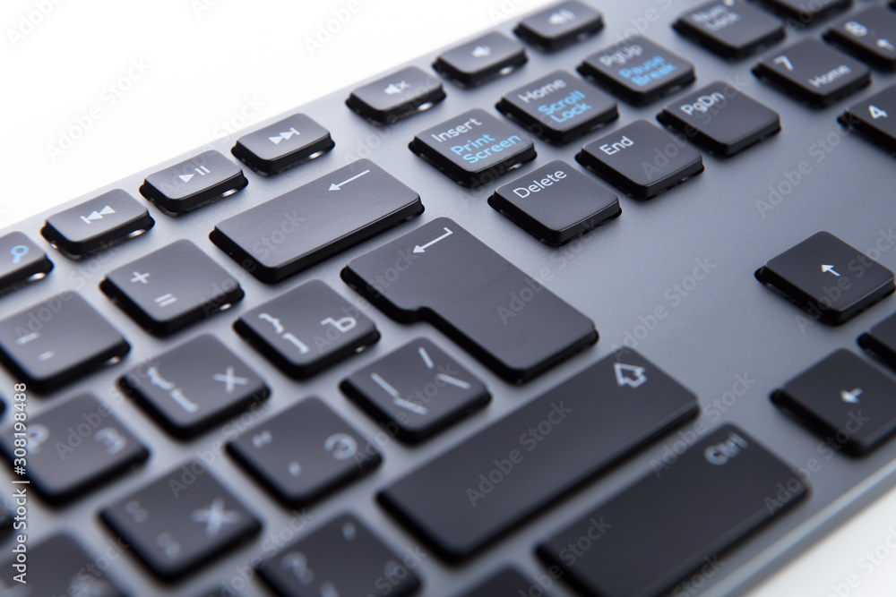 Wireless gray keyboard on a white background close-up. Wireless gray keyboard on a white background close-up.