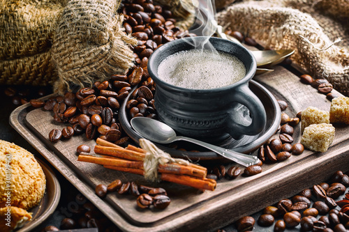 Coffee beans are roasted in a pan with smoke.