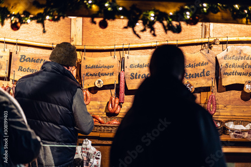 Food stall serving traditional food at a christmas market TRANSLATION FROM GERMAN different FANTASY SAUSAGES