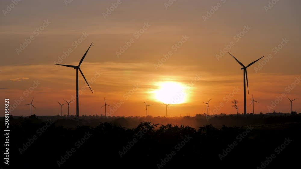 Scenic landscape of the wind turbine for electric power make against nature agriculture farm for renewable clean power from wind in twilight sunset time with dark and grain processed Scenic landscape of the wind turbine for electric power make against nature agriculture farm for renewable clean power from wind in twilight sunset time with dark and grain processed
