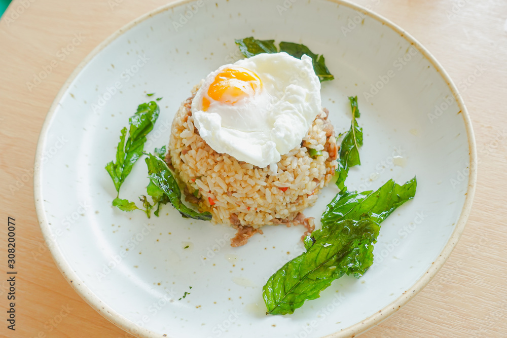 Fried rice with beef, holy basil and thai herb served with poached egg