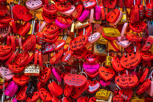 Verona  Italy - March 15  2019  Juliet house  red locks with inscriptions and wishes on wall with chewing gum