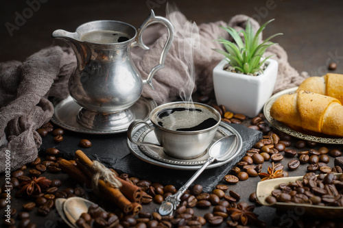 Coffee beans are roasted in a pan with smoke.