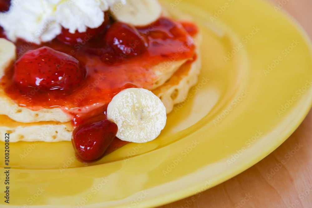Buttermilk pancake filled with sliced banana and strawberries Buttermilk pancake filled with sliced banana and strawberries